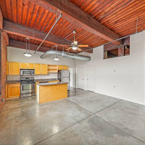 Unfunished living room with ceiling fan at Stadium Loft Apartments in Saint Louis, Missouri