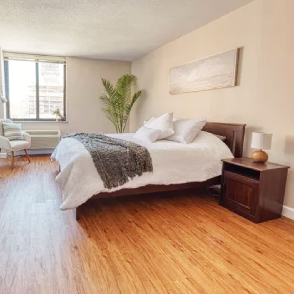 Spacious bedroom with wooden floor at Del Coronado Apartments in St. Louis,Missouri
