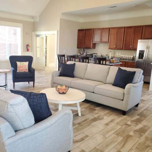 Resident clubhouse with comfortable seating and kitchenette at Groves at Peach Orchard in Belmont, North Carolina