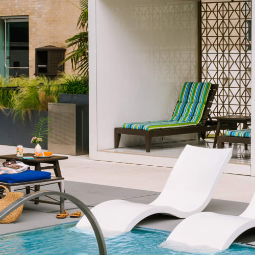 In pool lounge chairs at The Statler Residences, Dallas, Texas