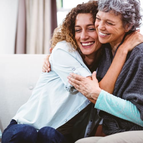 A resident hugs her mom at Chollas Heights Historical in San Diego, California