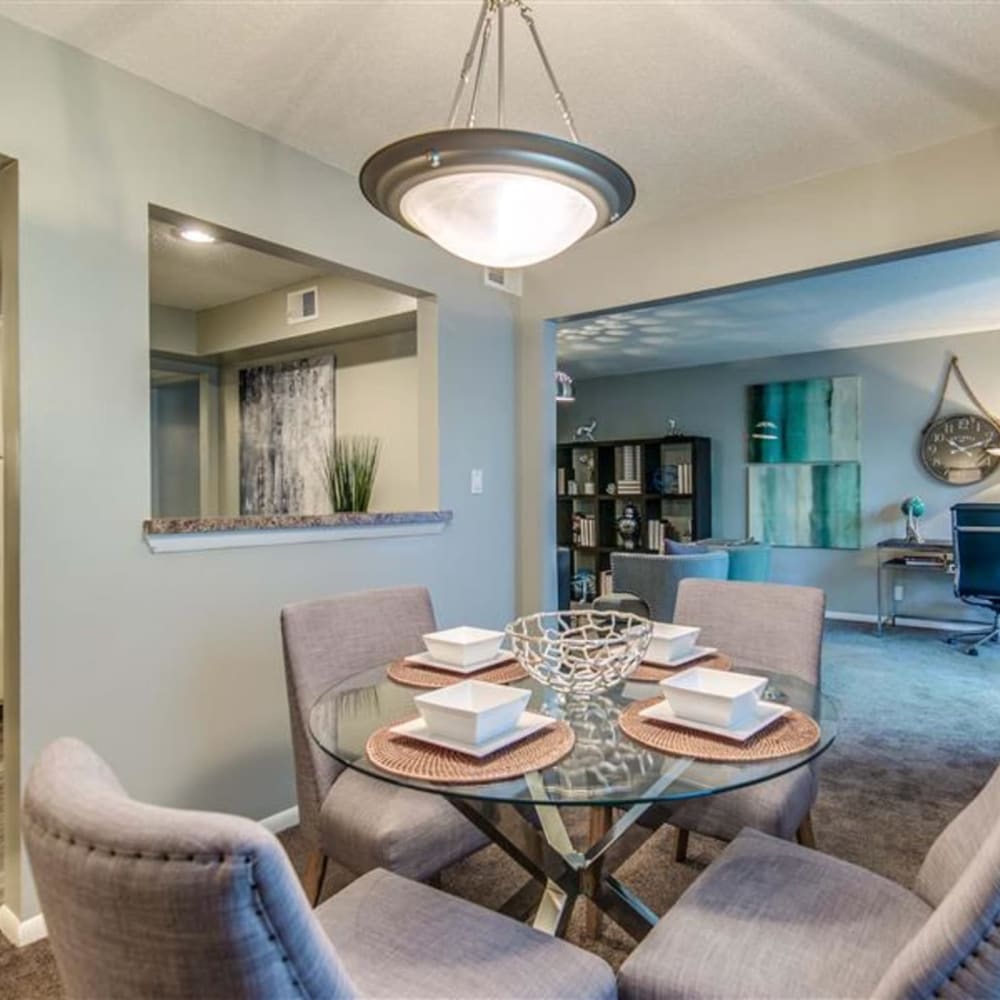 Dinning room with service counter and access to living room at London House Apartments in Lenexa, Kansas