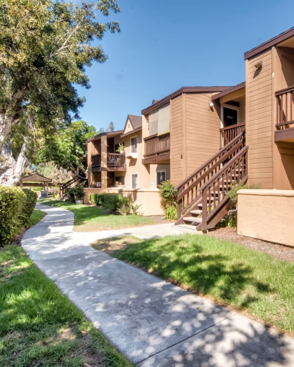 Exterior Building View with Beautiful Landscaping and walkway at Terra Nova Villas in Chula Vista