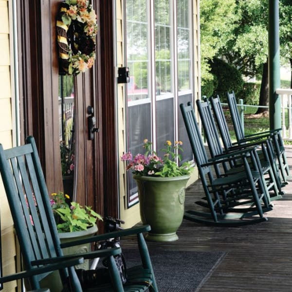Front porch with a row of seats at Quail Park of Granbury in Granbury, Texas