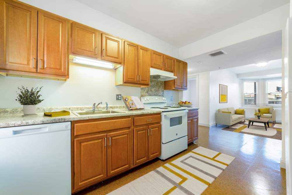 Modern kitchen with wooden cabinets at Memorial Square Apartments in Springfield, Massachusetts