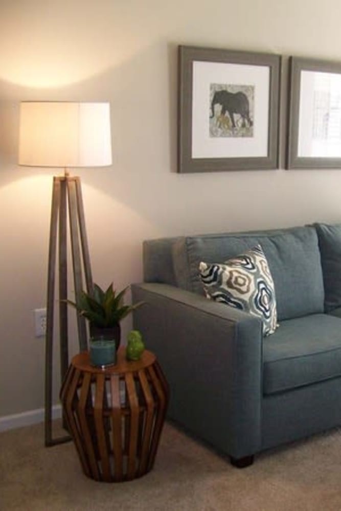 Modern living room with sofa at Oak Grove Crossing Apartments in Newburgh, Indiana