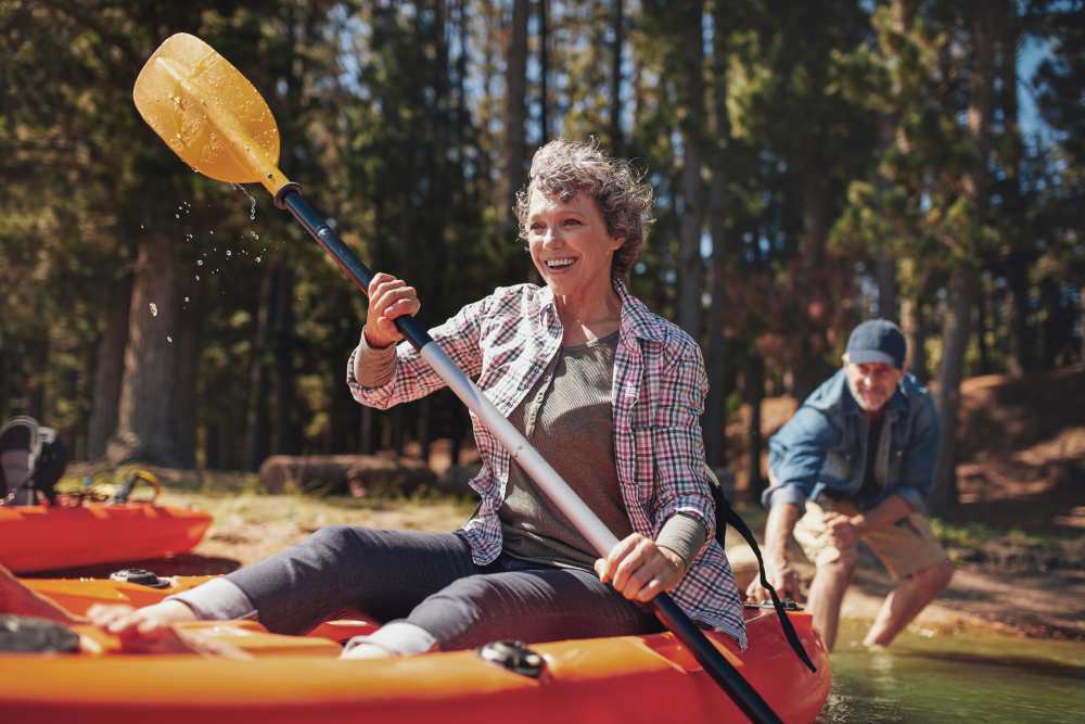 a woman paddling a kayak near Lake Forest at Swift Creek in Midlothian, Virginia