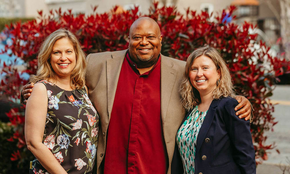 Executive team posing for a photo at a community by Cascade Senior Living Services
