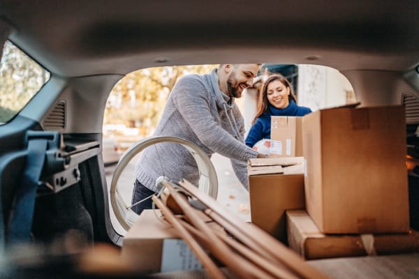 Young couple packing their SUV with home goods for a trip to YourSpace Storage @ Owings Mills in Owings Mills, Maryland