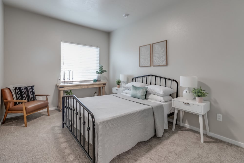 Carpeted model bedroom with lots of natural light at Olympus at Ten Mile in Meridian, Idaho