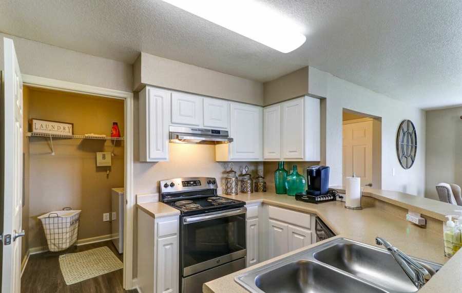 Kitchen with granite countertop and white wood cabinet at The Reserve at Kanapaha in Gainesville, Florida