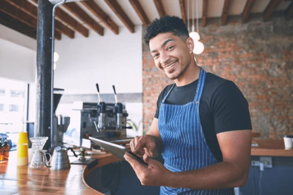 Barista working at a coffee shop near The District in Asheville, North Carolina
