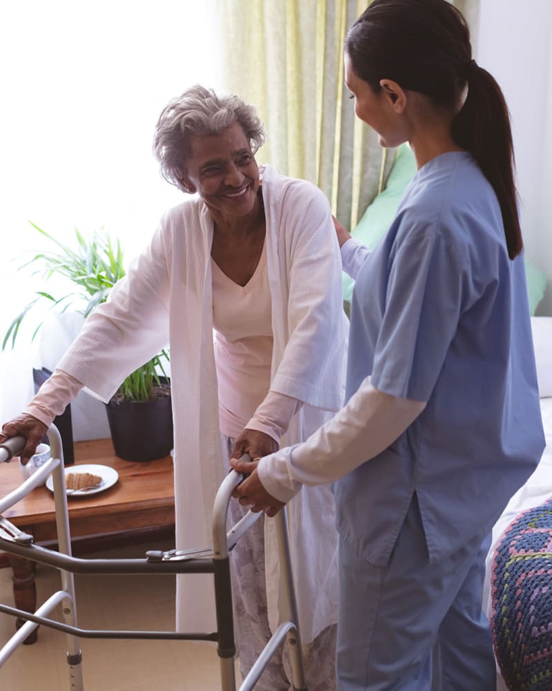 Resident with a walker in their apartment at Keepsake Village at Greenpoint in Liverpool, New York