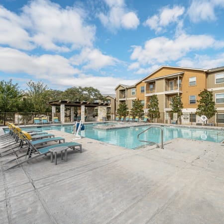 Exterior and sparkling pool of The Residences at Panther Hollow in the afternoon