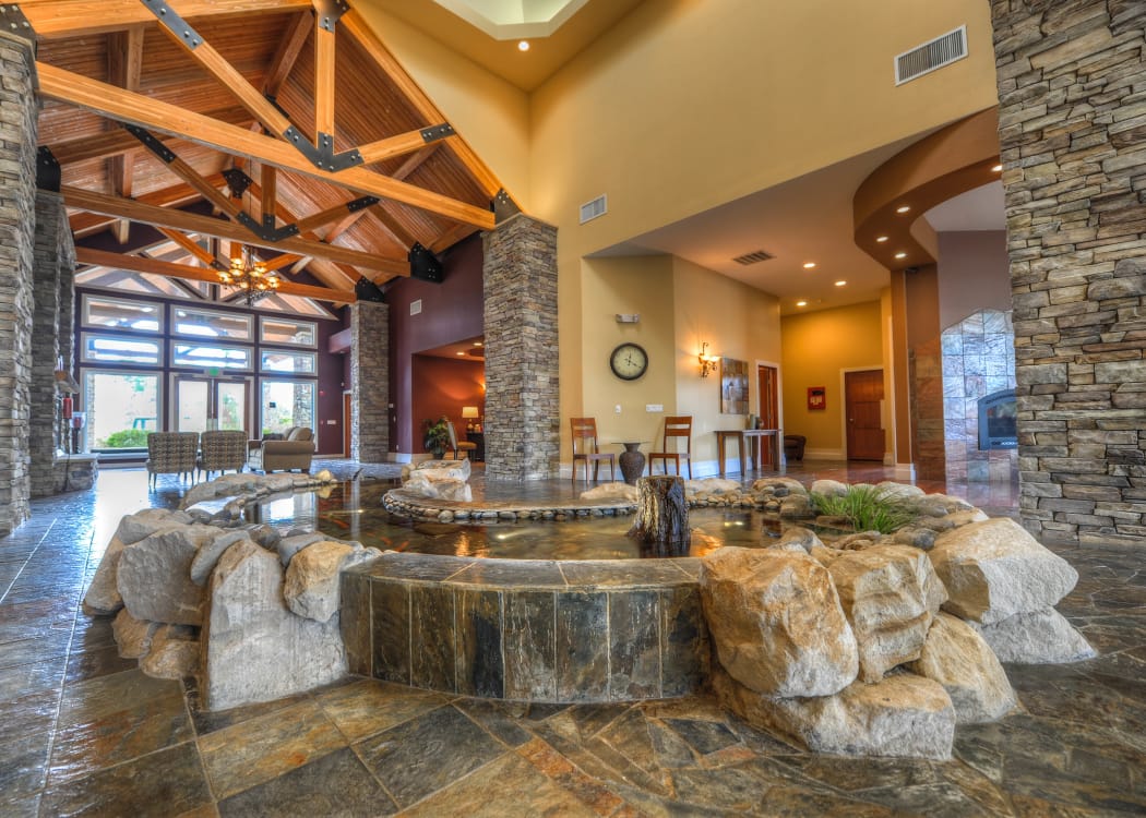 Lobby area with an indoor pond at Sierra Sun in Puyallup