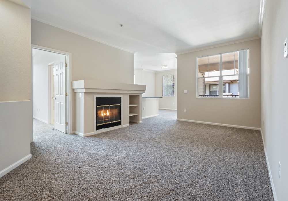 Living room with fireplace at Park Hacienda Apartments in Pleasanton, California