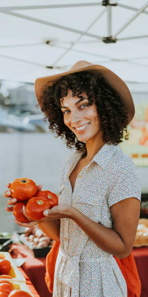 Woman shopping at a farmer's market near Emerald Park Apartment Homes in Dublin, California