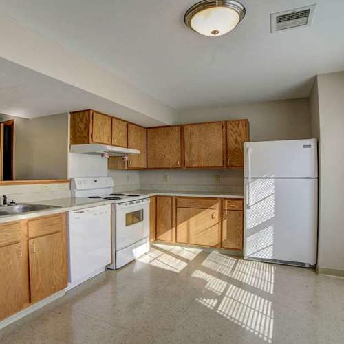 Kitchen with white appliances, storage spaces. hard flooring and large window at Raystown Crossing in Shippensburg, Pennsylvania