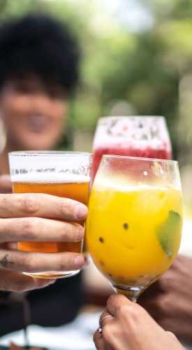 Hands holding colorful drink glasses near Fairways on Green Valley in Henderson, Nevada