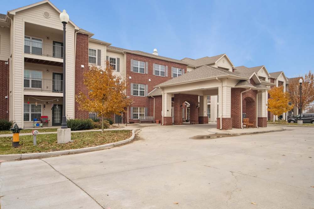 Charming brick facade with community porch and landscaped entryway at Villas At Meadow Springs in Ankeny, Iowa