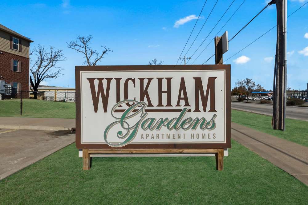 Wickham Gardens apartment sign in landscaped surroundings at Wickham Gardens in Sapulpa, Oklahoma