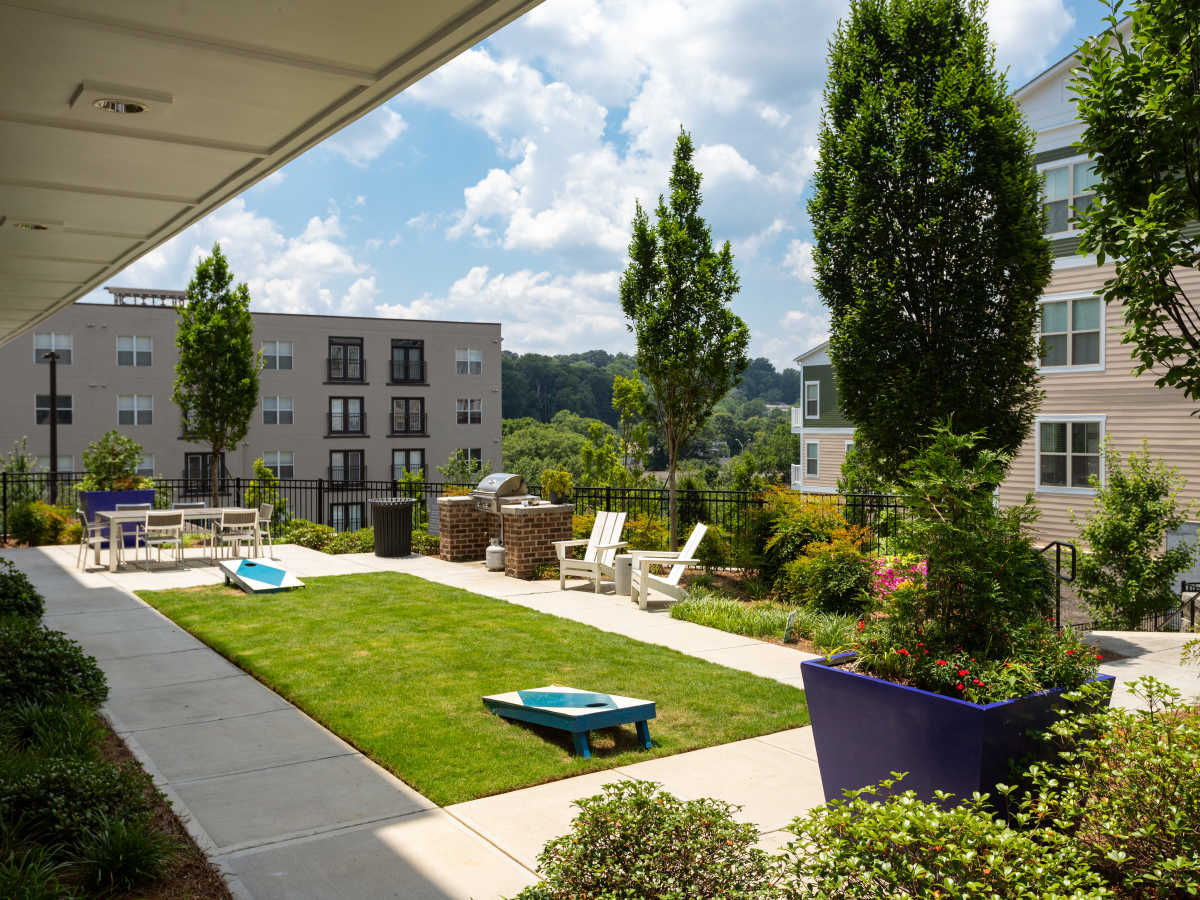 Modern green lawn with seating and trees at Ardmore & Twenty Eighth in Atlanta, Georgia