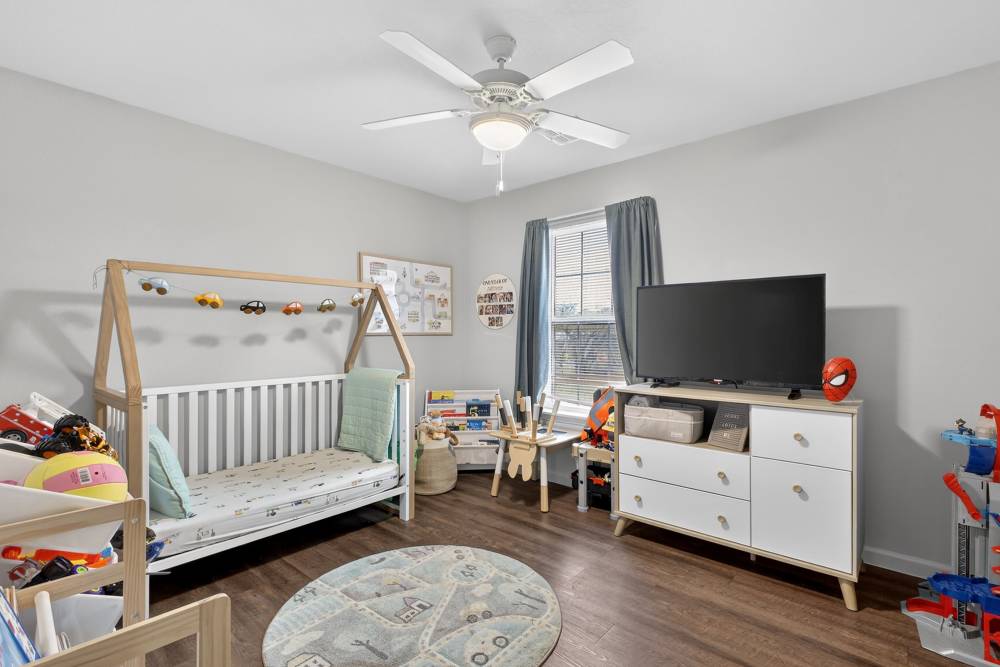 Charming children's bedroom featuring playful decor and ample natural light at Lakewood Crossing in Granbury, Texas.