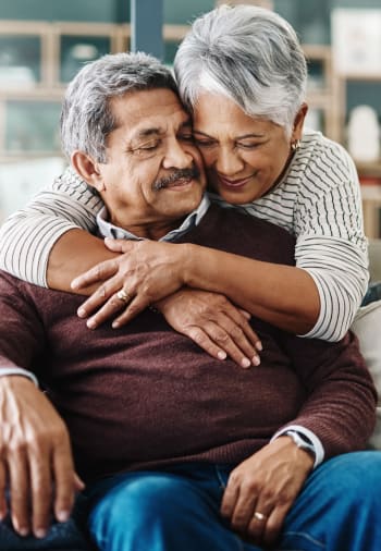 A resident couple hugging at The Claiborne at Baton Rouge in Baton Rouge, Louisiana. 