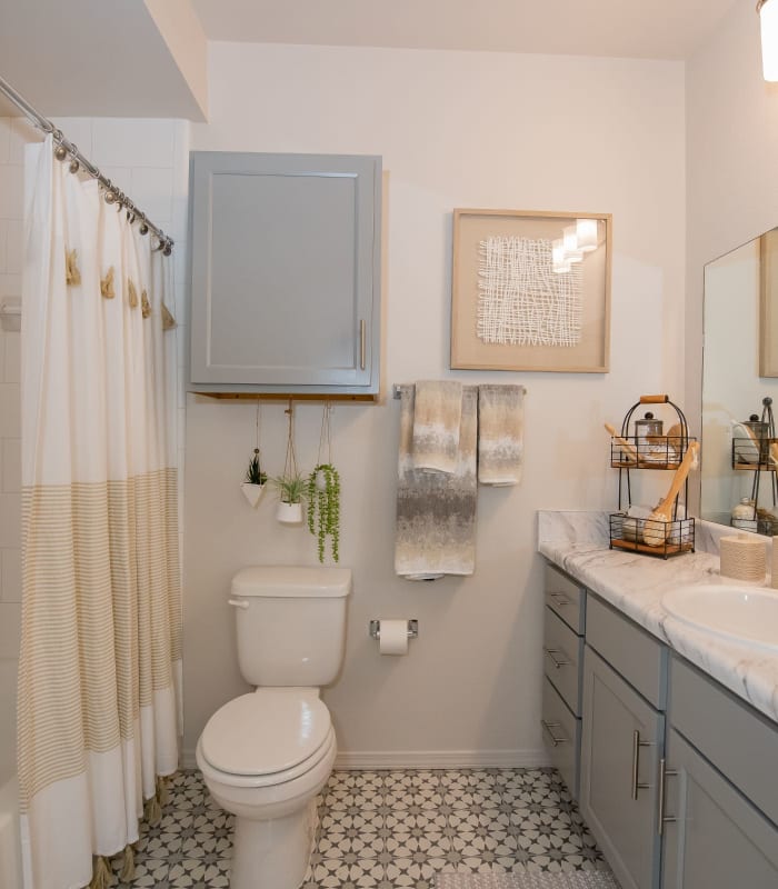 Bathroom with tile flooring at Center 301 Apartments in Belton, Missouri