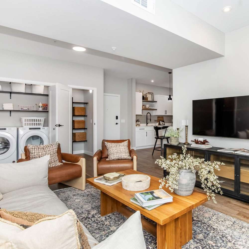 Spacious living room with large couch, chairs, coffee table and flat screen television at InterUrban 2.0 in Billings, Montana