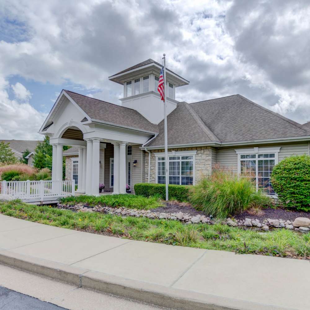 Charming entrance with lush landscaping at Boulder Springs in Maryland Heights, Missouri.