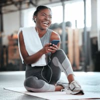 A woman stretching in the fitness center at Mode at Owings Mills in Owings Mills, Maryland