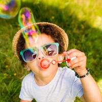 A child blowing bubbles at Dickinson Apartments in Springfield, Illinois