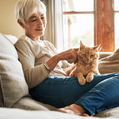 A woman with a cat on her lap at Milestone Retirement Communities