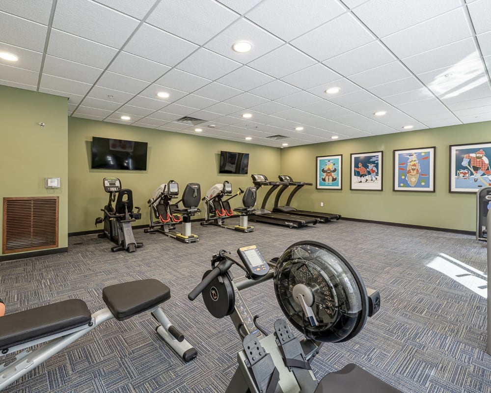 Fitness center with weight machines and cardio equipment at The Pillars of Hermantown in Hermantown, Minnesota