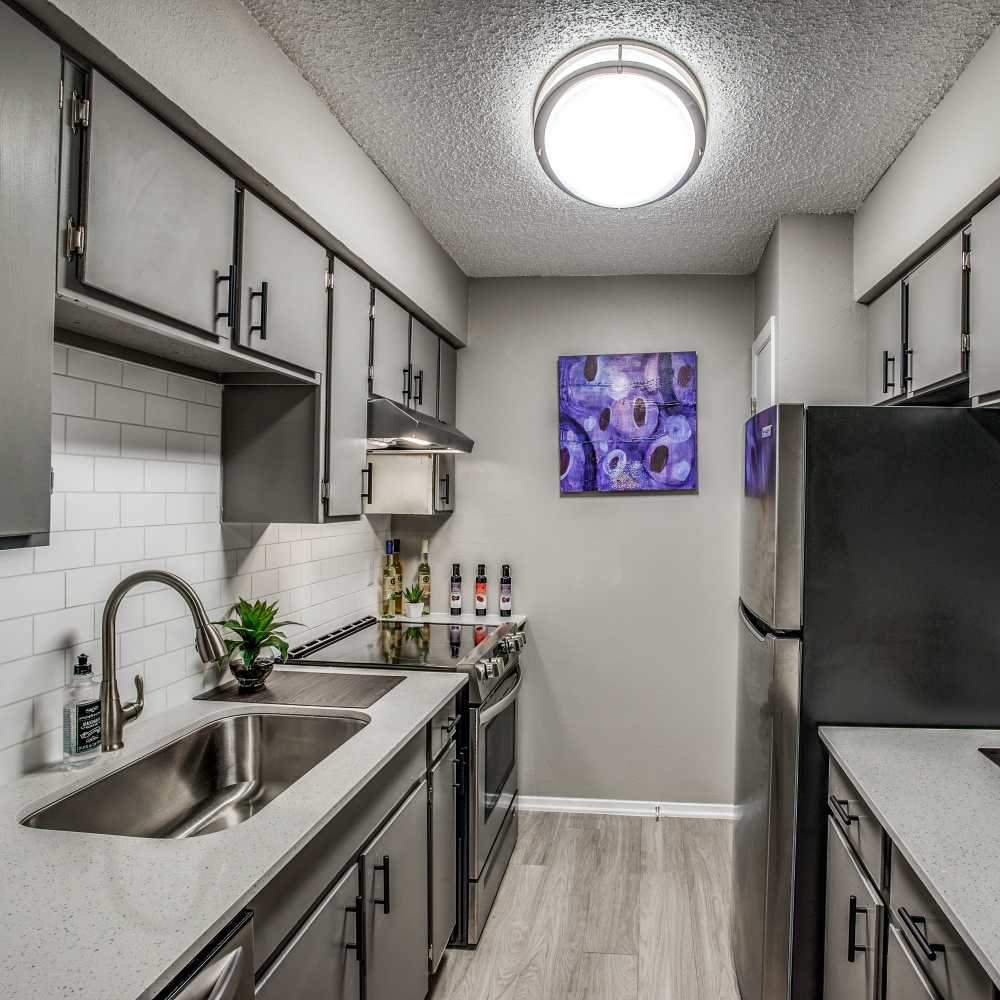 Modern kitchen with stainless steel appliances at Sagamore Apartments in Benbrook, Texas