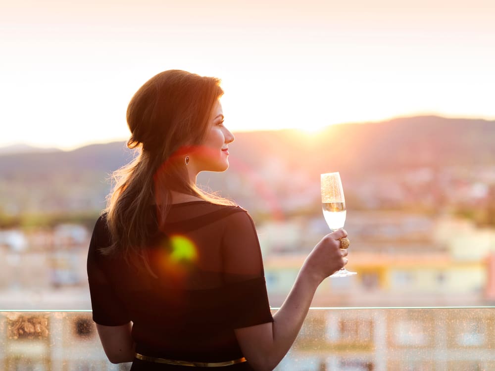 Resident drinking wine from the balcony at Mira Santi in Chandler, Arizona