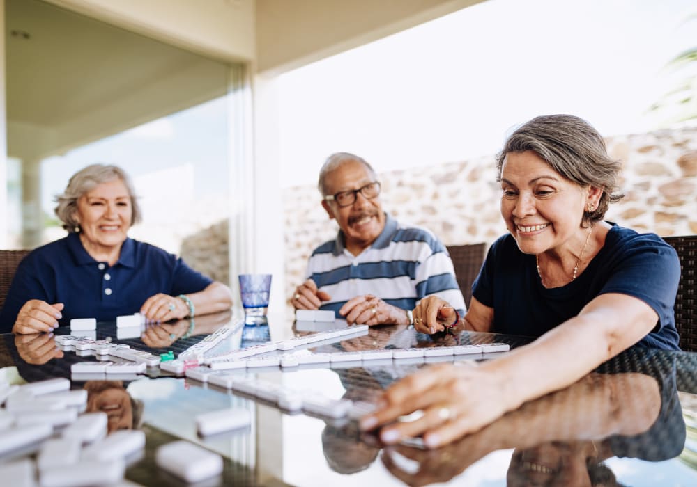 A group of resident friends playing a game at a Merrill Gardens community.