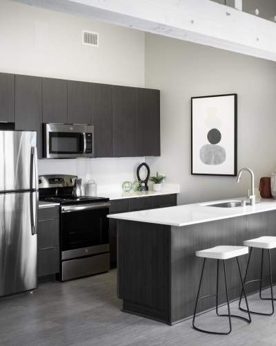 Kitchen with stainless-steel appliances at Breve Park Apartment Homes, Anaheim, California