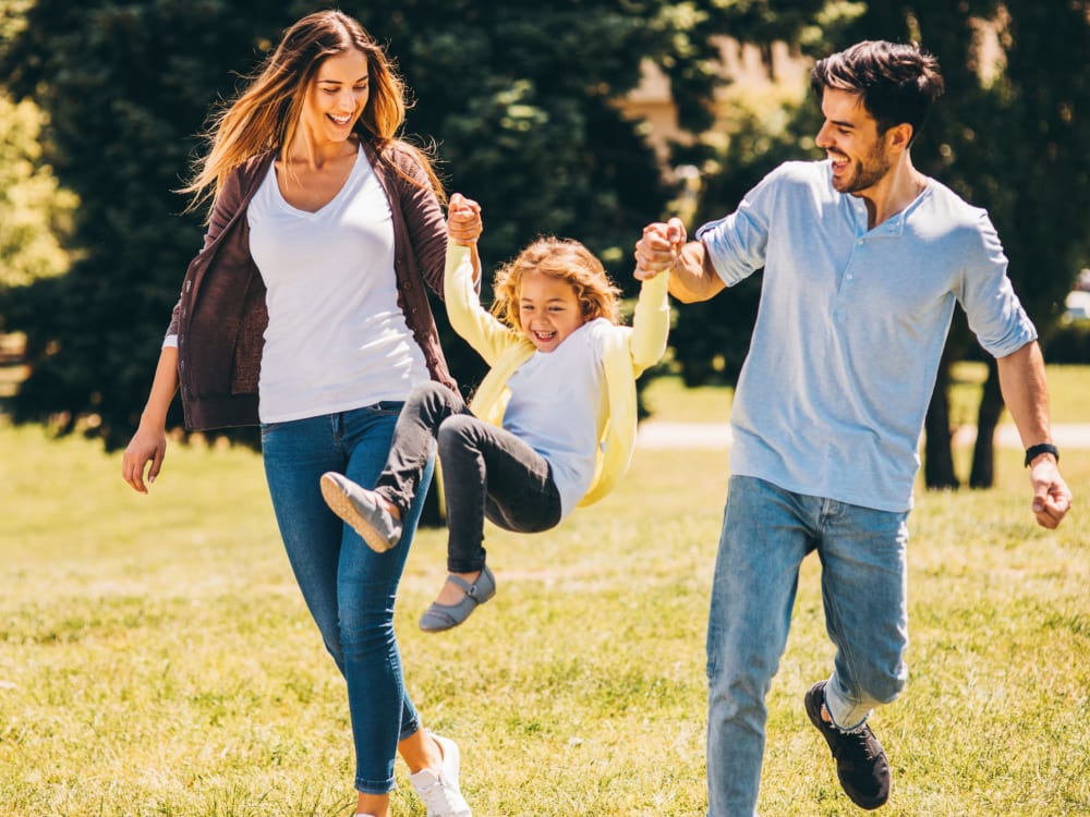 Couple taking their kid for a stroll through the neighborhood at Packard West Hartford in West Hartford, Connecticut