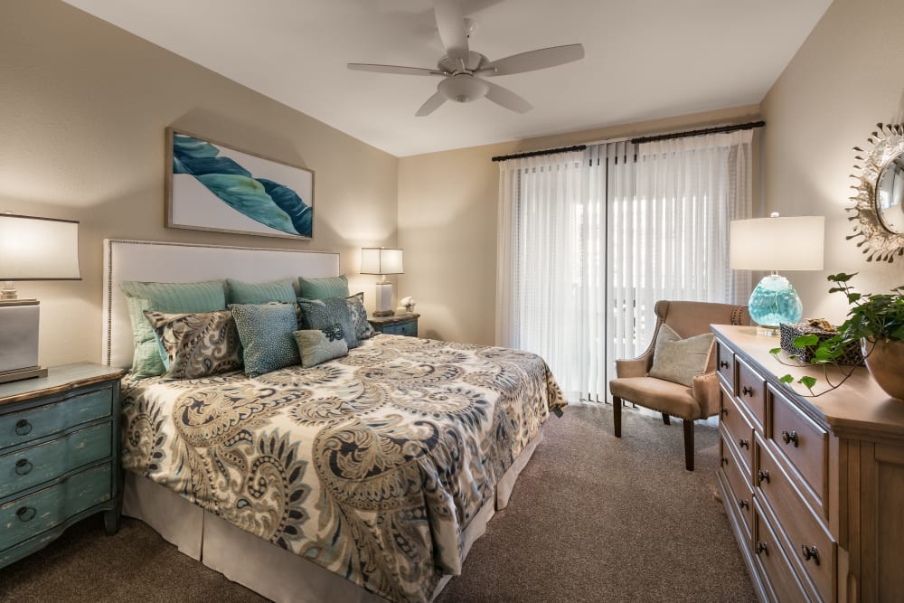 Large master bedroom with ceiling fan and beautiful furnishings in model home at San Villante in Mesa, Arizona