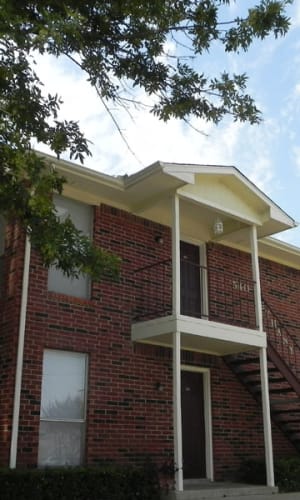 Brick building exterior at Dove Hollow Apartments in Allen, Texas