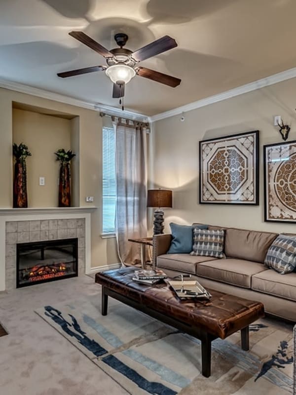 Living room with fire place at Chateau Mirage Apartment Homes in Lafayette, Louisiana