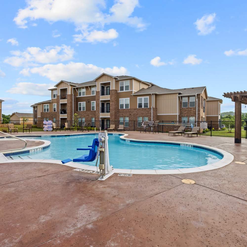 Swimming pool with community building view at Deer Park in Athens, Texas