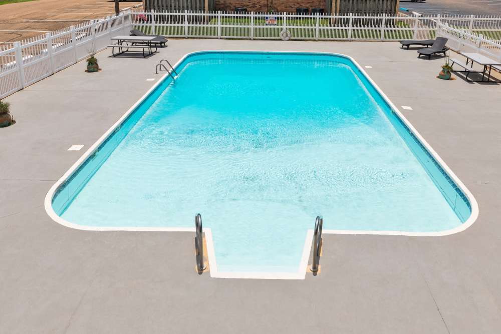 Vibrant sparkling water pool surrounded by elegant lounging areas at Pecan Ridge in Vicksburg, Mississippi.
