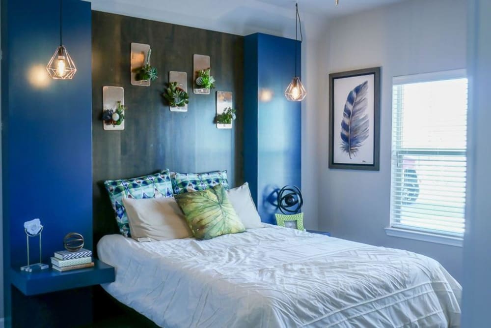 Model bedroom with pendant lighting at Biltmore at the Park in Pflugerville, Texas