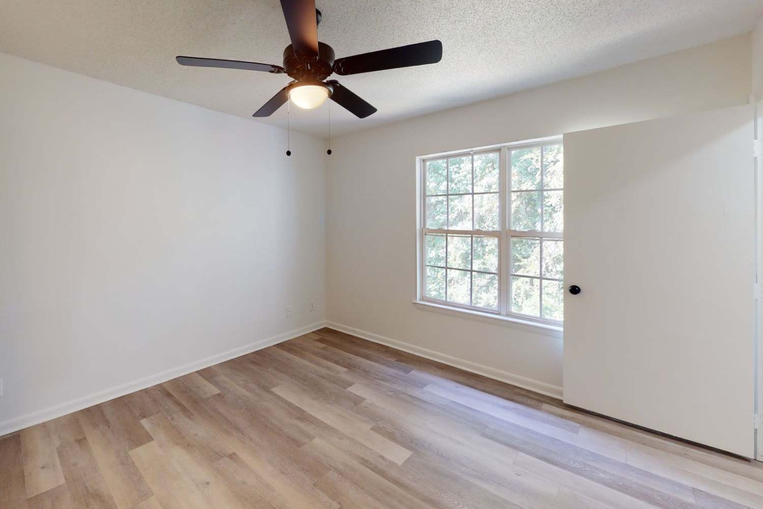 Unfurnished bedroom with ceiling fan at Wallace Terrace Apartments in Charlotte, North Carolina  
