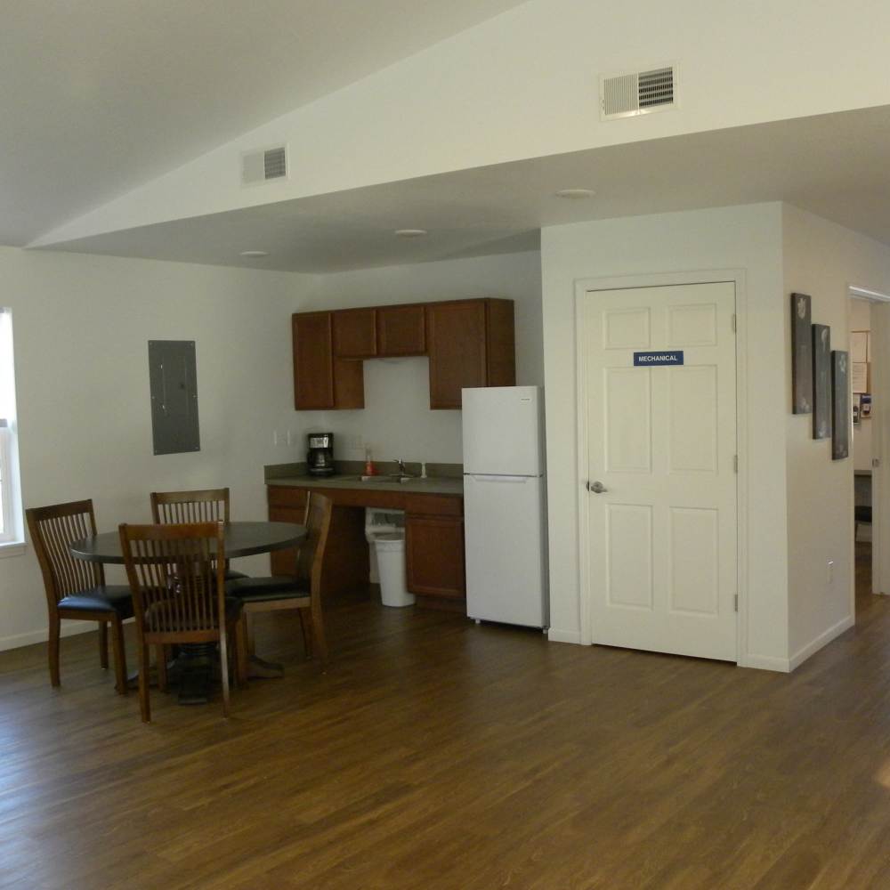 Kitchen with dining table with wooden flooring at Manistique Lakeview in Manistique, Michigan