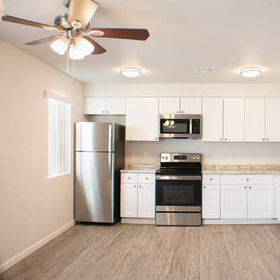 Kitchen with appliances and wooden flooring at Sand Pebble and Spanish Oaks in Sparks, Nevada