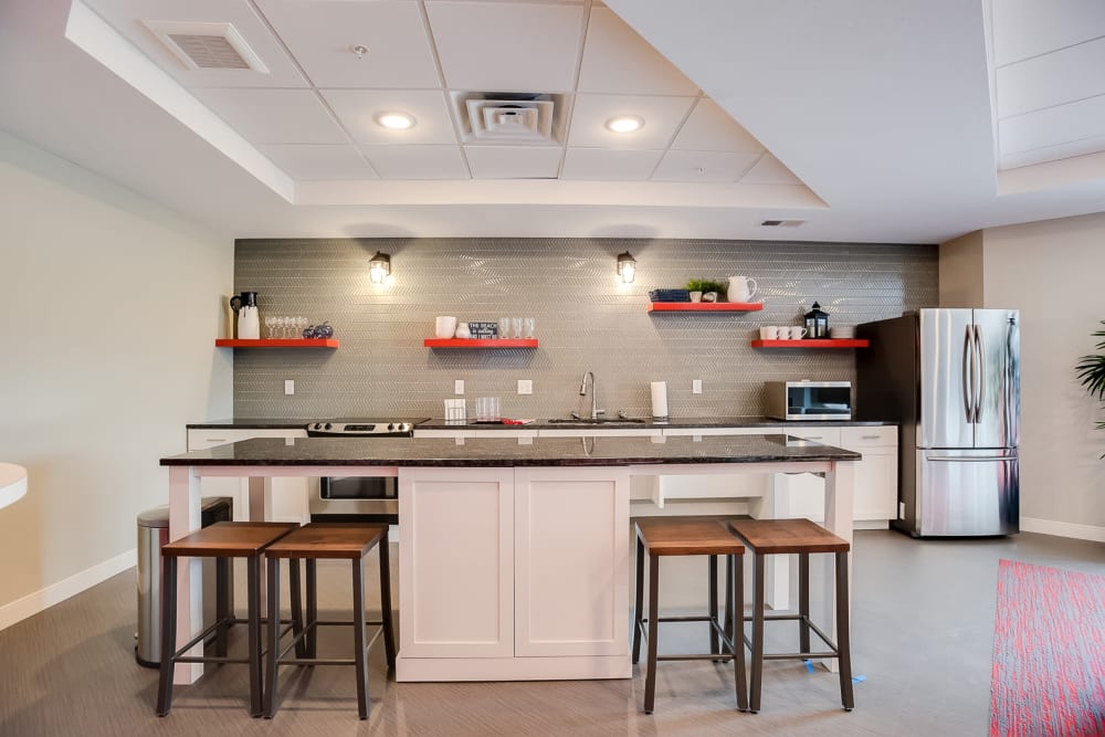 A community kitchen with bar seating at Lake Jonathan Flats in Chaska, Minnesota